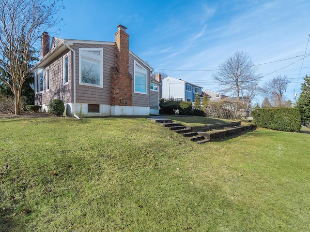 view of side of property featuring a yard