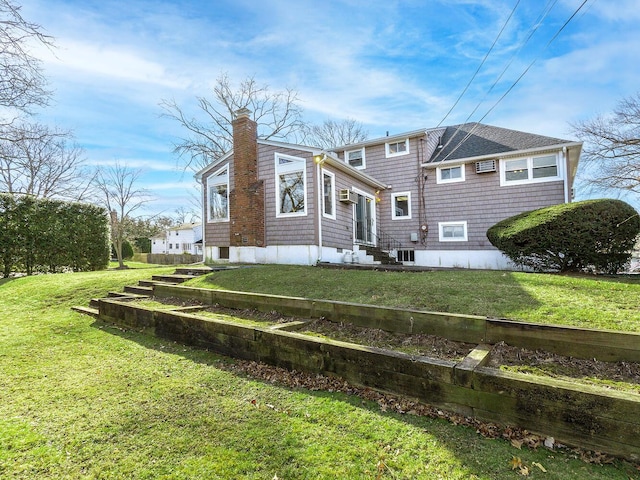 rear view of property featuring a lawn