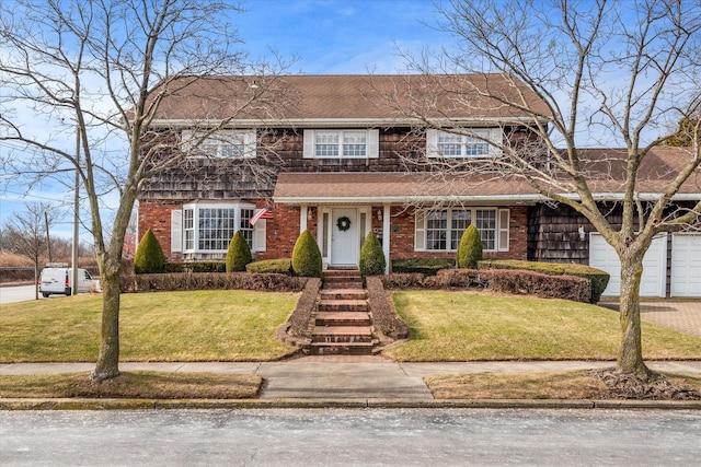 view of front of property featuring a garage and a front lawn