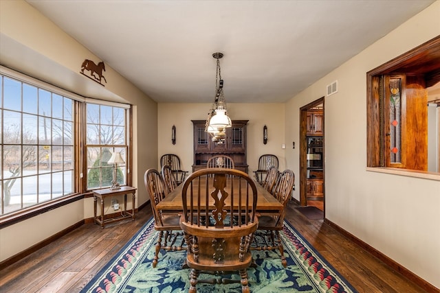 dining area with dark wood-type flooring