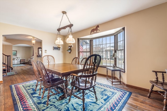 dining space with dark hardwood / wood-style floors