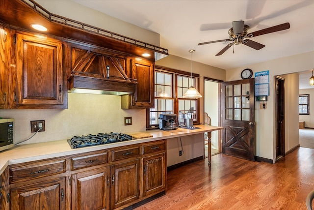 kitchen featuring black gas stovetop, hardwood / wood-style floors, pendant lighting, and ceiling fan