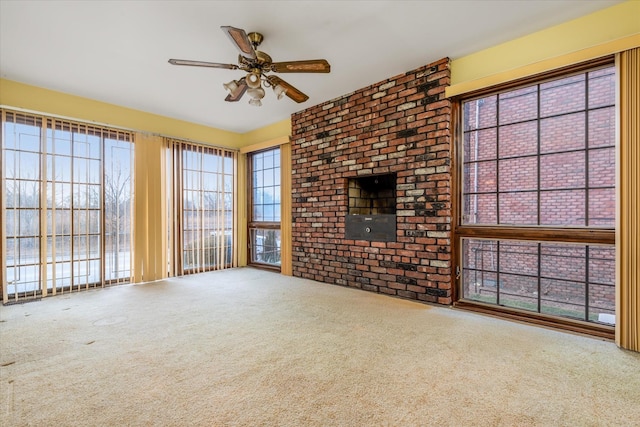 unfurnished living room with ceiling fan and carpet floors