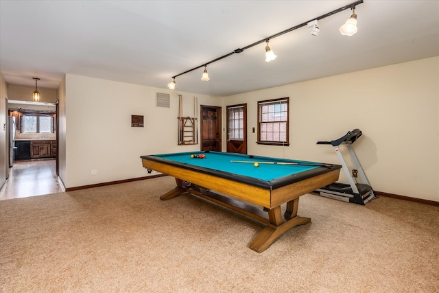 recreation room with carpet flooring, rail lighting, and a healthy amount of sunlight