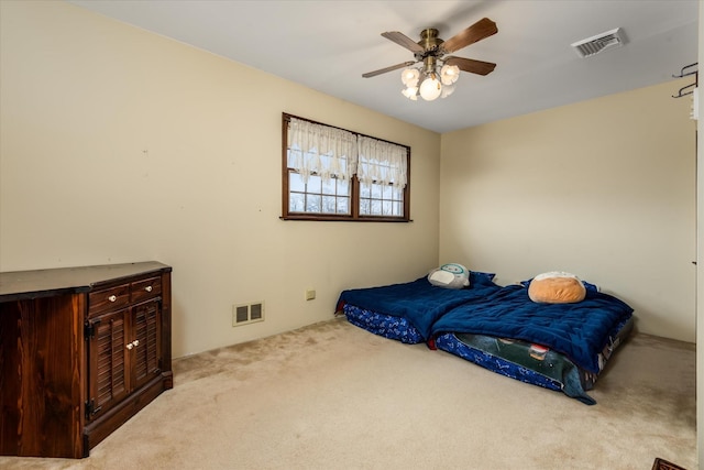 bedroom featuring ceiling fan and light carpet