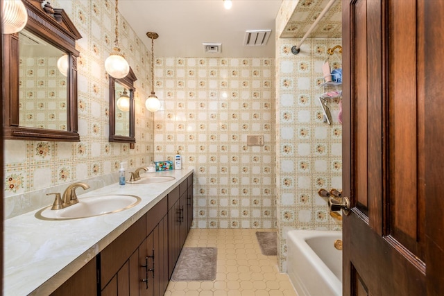 bathroom featuring vanity and tub / shower combination