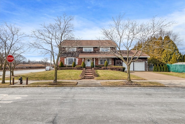 view of front of house featuring a garage and a front lawn