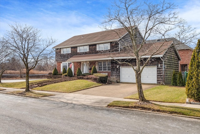 view of front of house featuring a garage and a front lawn