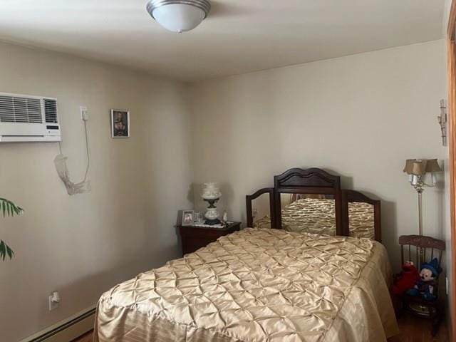 bedroom with a baseboard radiator and a wall mounted air conditioner