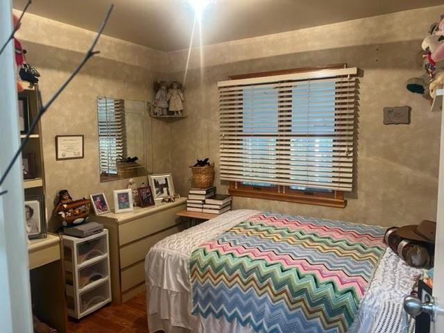 bedroom with dark wood-type flooring