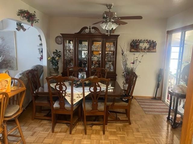 dining space featuring ceiling fan and light parquet floors