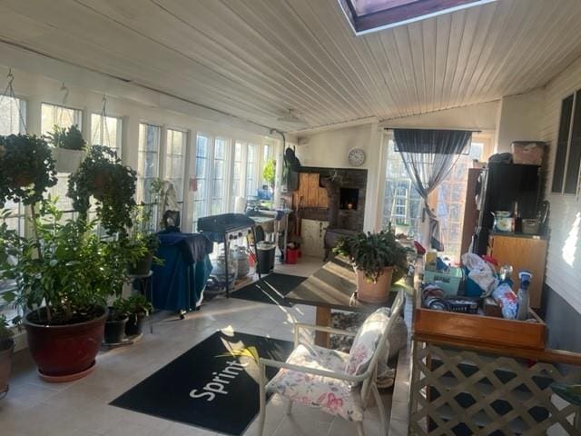 sunroom with a healthy amount of sunlight and a fireplace