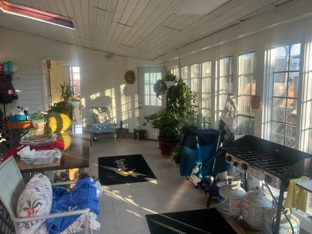 sunroom / solarium with a wealth of natural light, wood ceiling, and vaulted ceiling