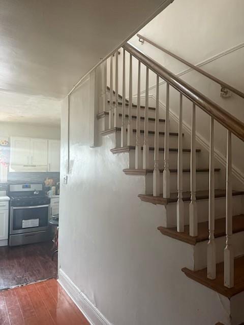 stairs featuring hardwood / wood-style flooring