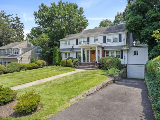 colonial house with a garage and a front yard