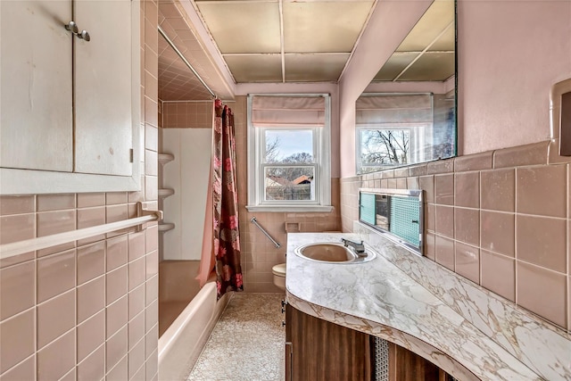 full bathroom featuring shower / bath combo, toilet, vanity, and tile walls