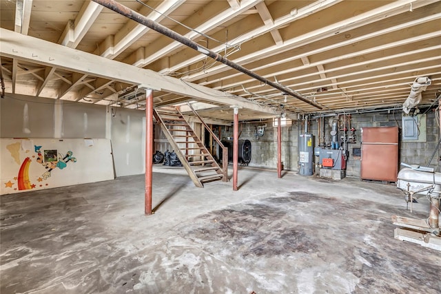 basement featuring refrigerator and water heater