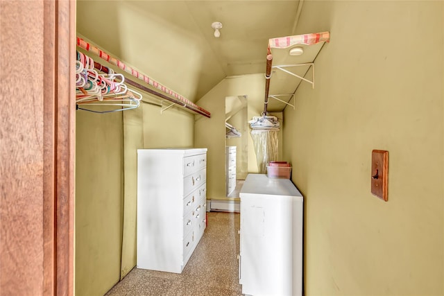 clothes washing area with light colored carpet and a baseboard heating unit