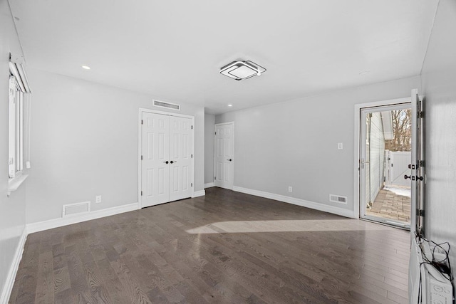 spare room with dark hardwood / wood-style flooring