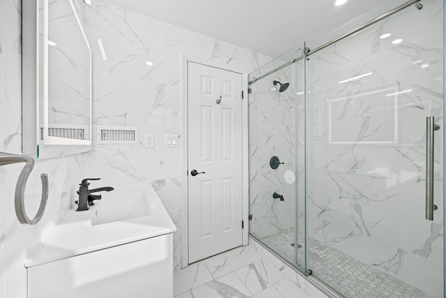 bathroom featuring walk in shower and vanity