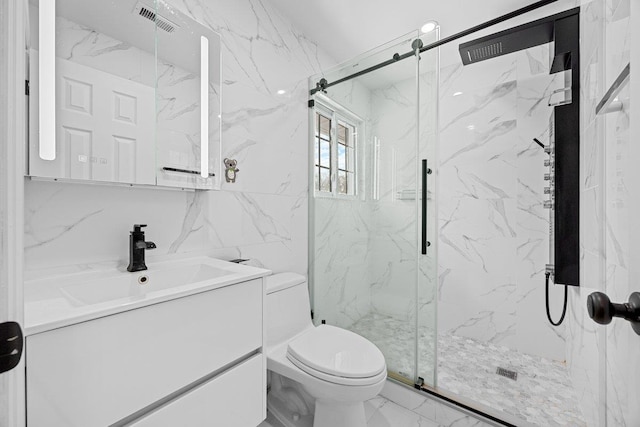 bathroom featuring a shower with door, vanity, tasteful backsplash, tile walls, and toilet