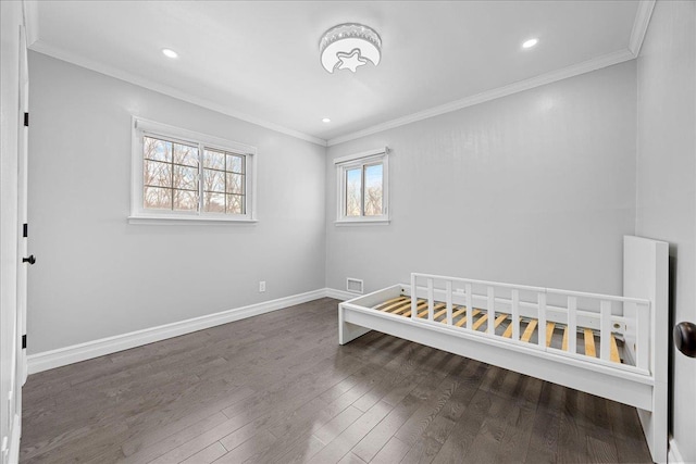 unfurnished bedroom with crown molding and dark hardwood / wood-style flooring