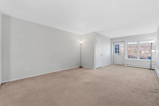 carpeted empty room featuring a baseboard radiator