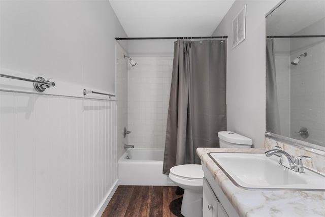 full bathroom with vanity, hardwood / wood-style floors, shower / bath combo, and toilet