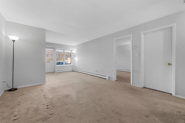 unfurnished living room with baseboard heating and light colored carpet