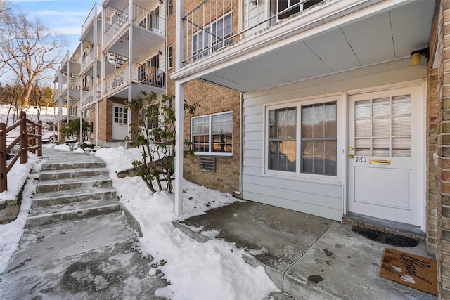 view of snow covered property entrance