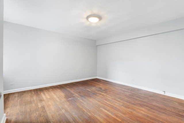 spare room with dark hardwood / wood-style flooring