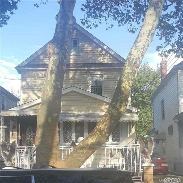 rear view of house with covered porch