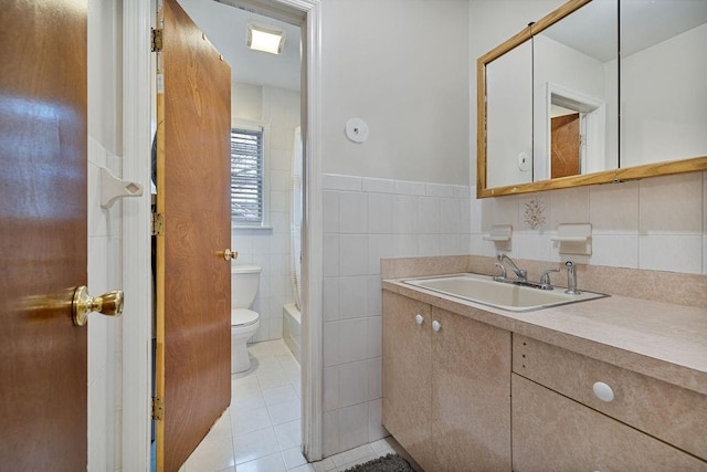 full bathroom featuring tile walls, shower / bath combination with curtain, vanity, toilet, and tile patterned floors