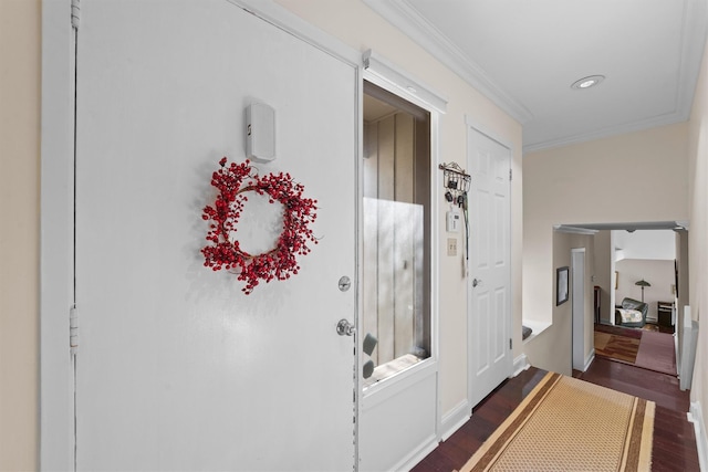 interior space featuring ornamental molding and dark wood-type flooring