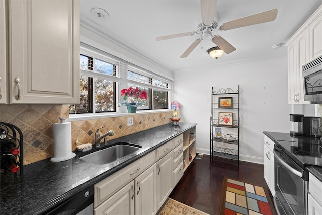 kitchen featuring appliances with stainless steel finishes, sink, white cabinets, backsplash, and dark wood-type flooring