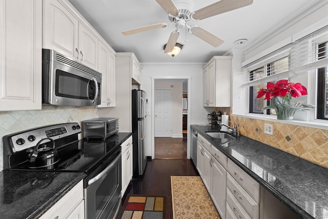 kitchen featuring appliances with stainless steel finishes, sink, and white cabinets