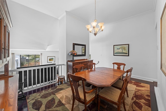 dining space featuring ornamental molding, dark hardwood / wood-style floors, and an inviting chandelier