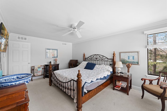 carpeted bedroom featuring ornamental molding and ceiling fan