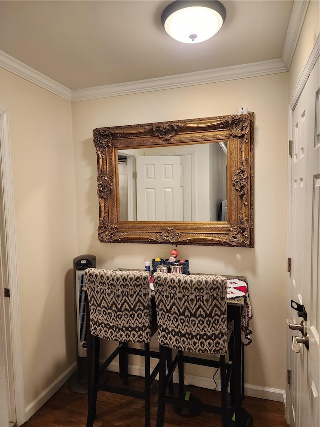 dining area featuring ornamental molding and dark wood-type flooring