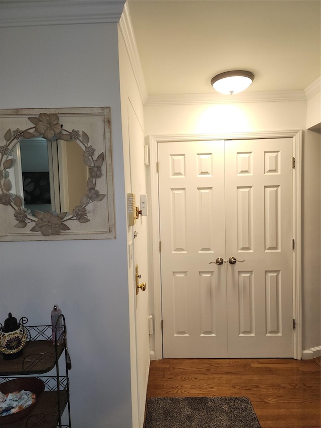 doorway to outside featuring dark hardwood / wood-style flooring and ornamental molding