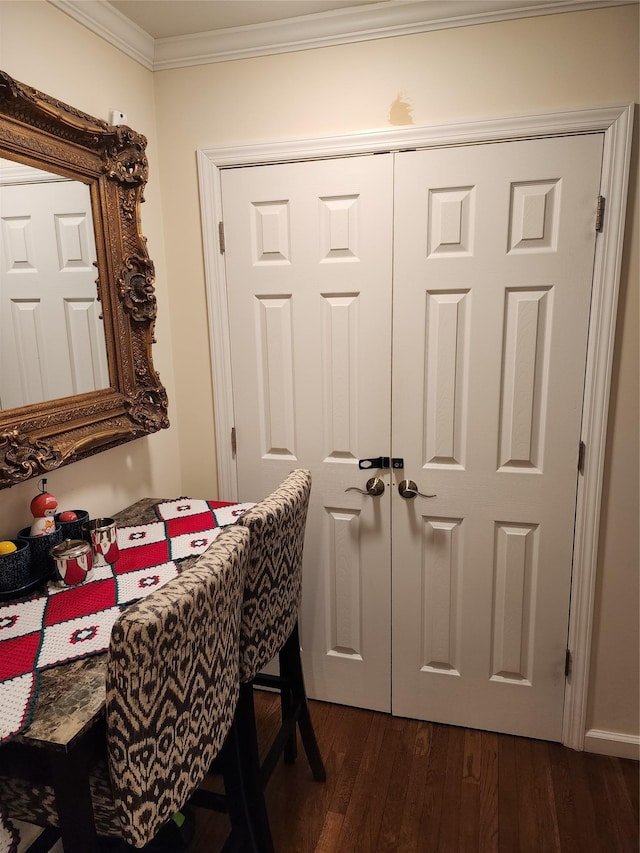 dining room with crown molding and dark wood-type flooring