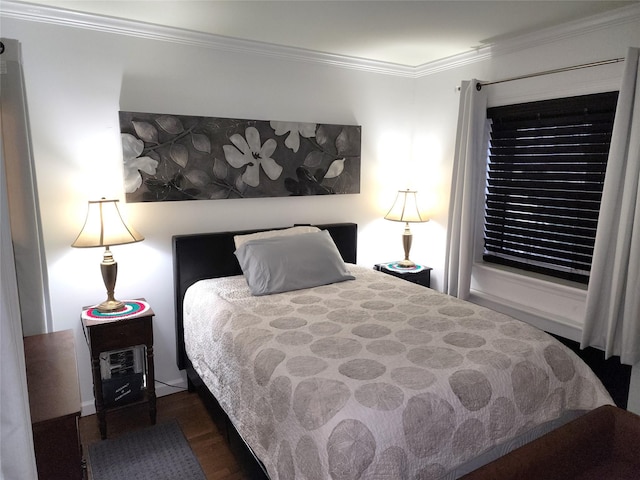 bedroom featuring ornamental molding and dark hardwood / wood-style floors