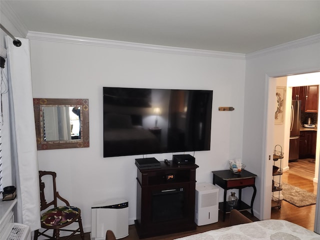 bedroom with dark hardwood / wood-style flooring, ornamental molding, and stainless steel refrigerator