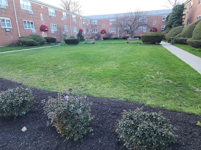 view of home's community featuring a lawn