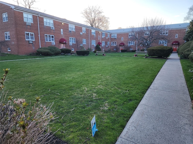 view of home's community with a yard