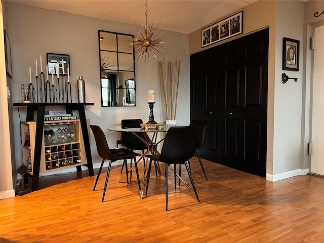 dining area featuring an inviting chandelier and wood-type flooring