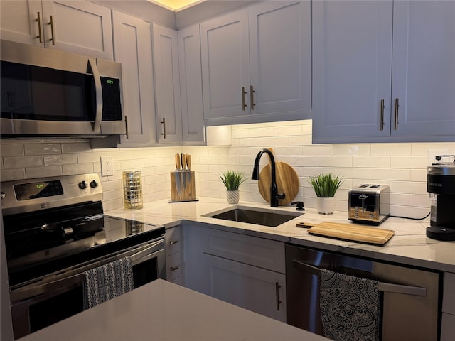 kitchen featuring tasteful backsplash, stainless steel appliances, beverage cooler, and sink