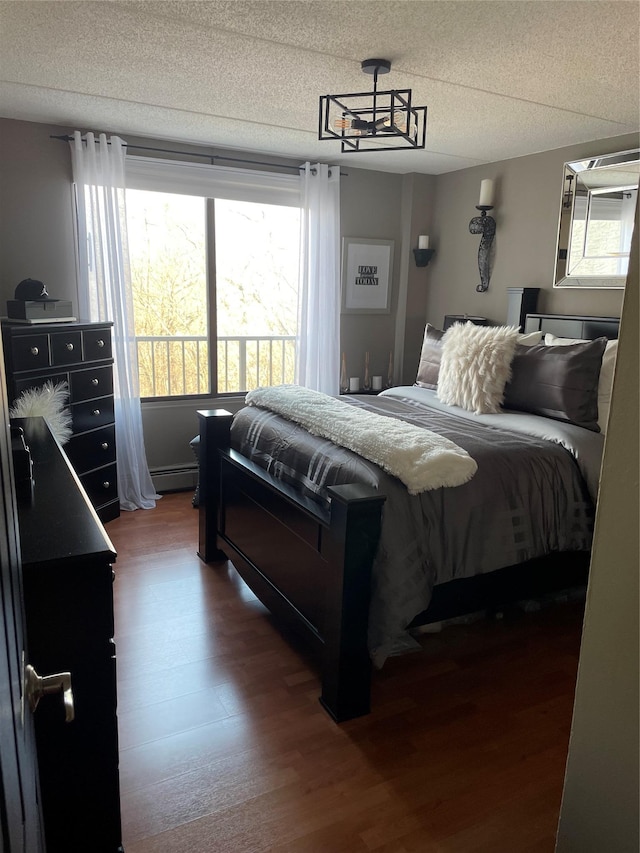 bedroom featuring a baseboard radiator and dark hardwood / wood-style flooring