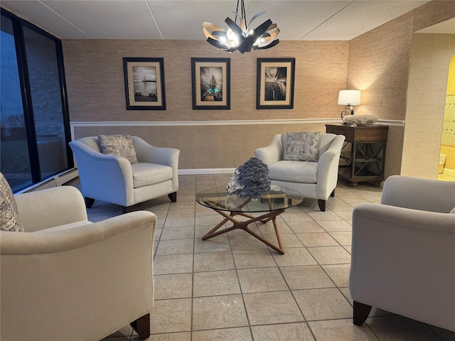 tiled living room with an inviting chandelier and baseboard heating