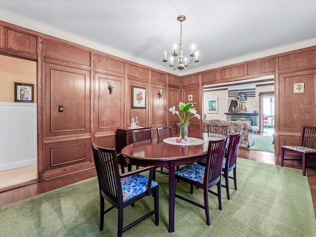 dining area featuring hardwood / wood-style floors and a notable chandelier